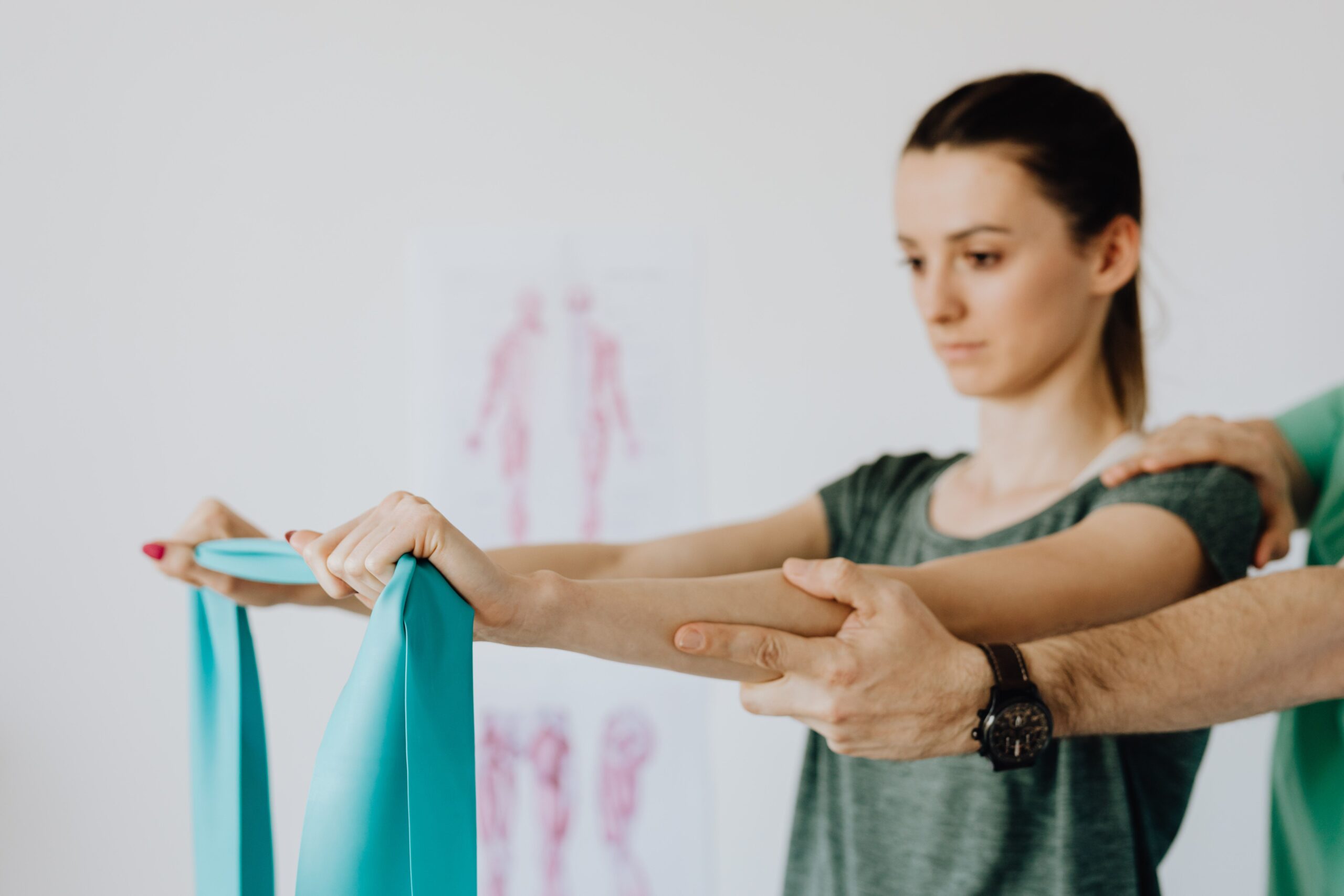 Physiotherapist guiding a patient through a shoulder mobility exercise in Oakville